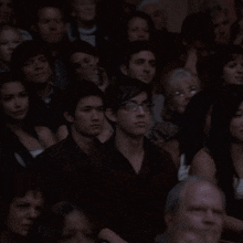 a group of people sitting in a dark room