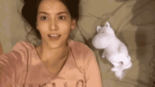 a woman is taking a selfie with a stuffed animal .