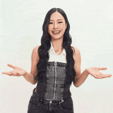a woman with her arms outstretched and a white shirt on