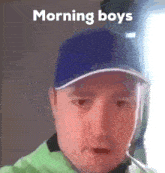 a man wearing a blue baseball cap is smoking a cigarette .