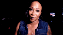 a woman with a tattoo on her arm is wearing a red wristband that says ' np ' on it