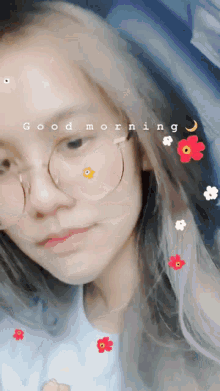 a girl with glasses and flowers on her face has the words good morning written on her face