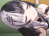 a girl with a cross in her hair is laying on a couch