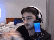 a man wearing headphones is talking into a microphone .