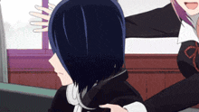 a girl with black hair is being held by another girl in a room