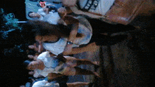 a group of people are standing in a dark room and one of them is wearing a shirt that says ' a '