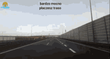 a blurred image of a highway with the words bardzo mocno placesz traso