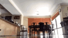 a living room with a dining table and chairs and a kitchen .