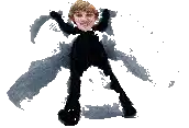 a person in a black suit is laying on the ground with their arms outstretched