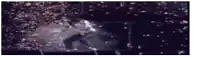 a blurry picture of a person standing in the dark with a lot of lights behind them .