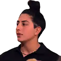 a close up of a woman 's face with a bun on her head