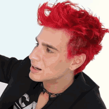 a man with red hair wearing a choker and a black jacket