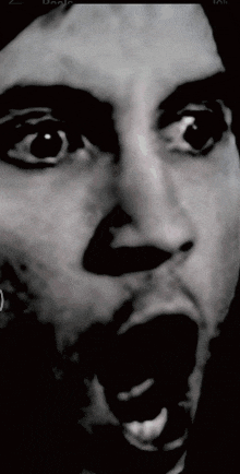 a black and white photo of a person 's face with their mouth open and their eyes closed