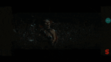 three girls are screaming in a dark room with a green s on the bottom left