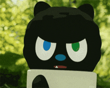 a black cat with blue eyes and green eyes