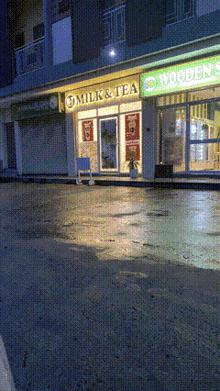a milk and tea store with a wooden sign