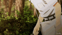 a man in a white shirt is standing in the woods holding a sword