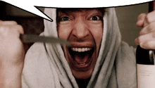 a man with his mouth open is holding a knife