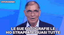 a man wearing glasses and a suit says le sue fotografie le ho strappate quasi tutte .