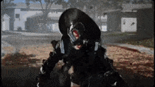 a person in a gas mask is standing on a sidewalk in front of a building .