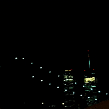 a blurry picture of a city skyline at night with a few buildings lit up