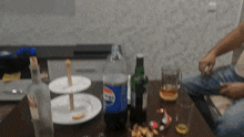 a bottle of pepsi sits on a table with other drinks