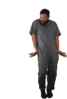 a man with a beard wearing a grey jumpsuit is dancing