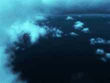 a dark cloudy sky with a few white clouds in it