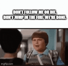 a boy with a backpack is talking to another boy in a hallway with the words do n't follow me or die .