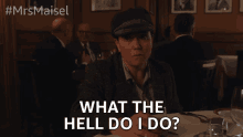 a woman sitting at a table with the words what the hell do i do