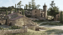 a church with a steeple sits in the middle of a village