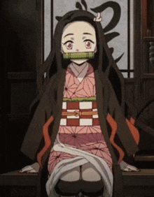 a girl in a kimono is sitting in front of a window