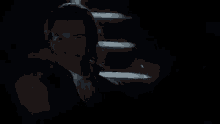 a man and a woman are standing in a dark room .