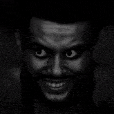 a close up of a man 's face with a black spot on his forehead