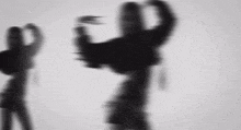 a black and white photo of a person 's shadow behind a glass .