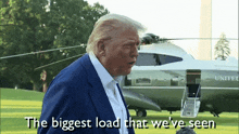 donald trump is standing in front of a united airlines plane