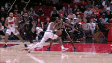 a basketball game is being played in front of a crowd with a player wearing a jersey with the number 44 on it