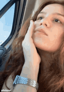 a close up of a woman 's face with the words gifsdayrol at the bottom