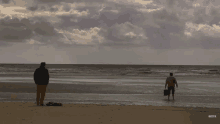 Roy In The Sea At The Beach With Tyrone Behind Him On The Sand Coronation Street GIF - Roy In The Sea At The Beach With Tyrone Behind Him On The Sand Coronation Street Roy Cropper GIFs