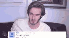 a man is sitting on a couch with a reply from alan