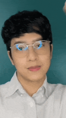 a man wearing glasses and a white shirt is making a funny face