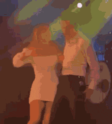 a man and a woman are hugging each other in a dark room