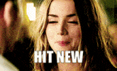 a woman with her eyes closed and the words hit new written on her face