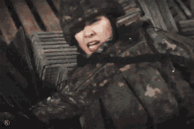 a woman in a military uniform is laying down with her mouth open