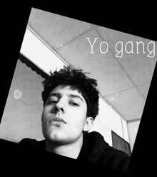 a black and white photo of a young man with the words yo gang on the bottom