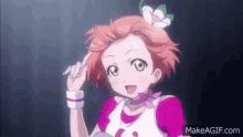 a girl with red hair and a flower in her hair is making a funny face .