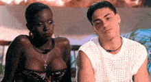 a man and a woman are looking at each other