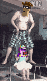 a man with a cardboard box on his head is dancing with a girl