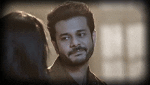 a man with a beard is looking at a woman in a black and white photo