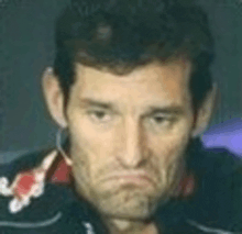 a man is wearing a headset and making a sad face .